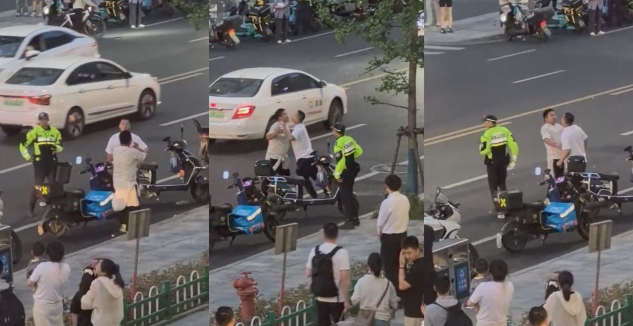 真是一场酣畅淋漓的街斗 旁边的交警都无语了 不知道的还以为哥两在调情呢