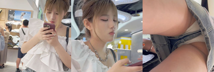 商场抄底超美高跟牛仔短裙丸子头美女 美女只顾玩手机 没想到被抄底白色内内