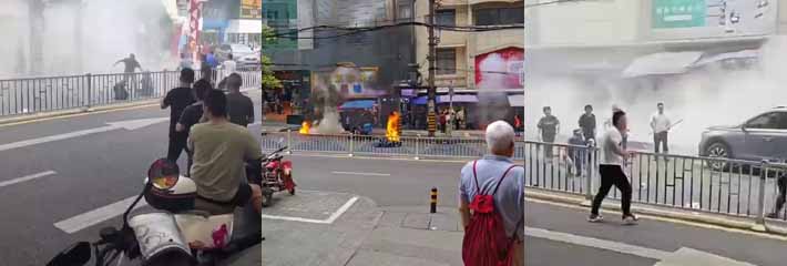 重庆渝中区陕西路一男子在门市外点燃自驾摩托车 欲寻衅滋事持刀伤人 被群众与民警合力制服