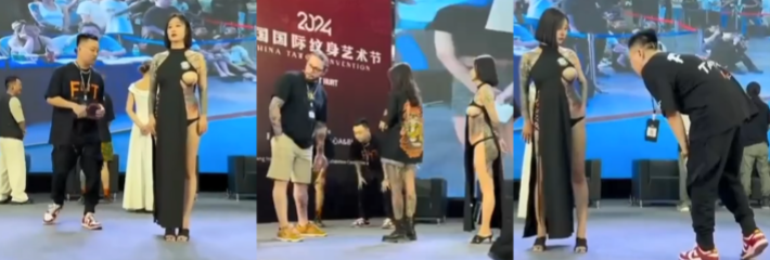 国际纹身艺术节 女模特露半只奶子 纹身鉴赏大赛 男的盯着看 吓得女模特赶紧捂住大乳头！