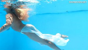 A woman floats in a butterfly-adorned mesh dress by Underwater Show: Big Tits, Babe & Blonde Porn - 经典欧美