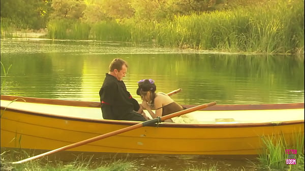 in_the_midst_of_a_lake_a_charming_pair_engaged_in_an_outdoor_activity_on_a_compact_watercraft